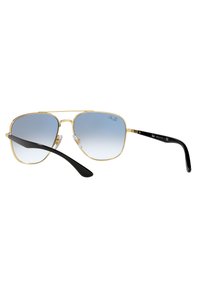 Occhiali da sole aviator con montatura in metallo dorato, lenti blu sfumate, astine nere e naselli regolabili per il massimo comfort.