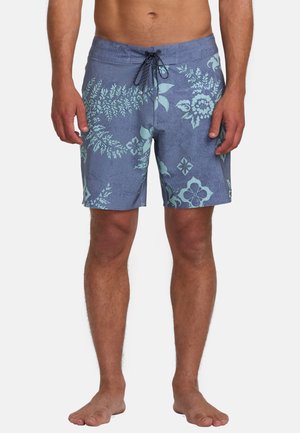 Bañador azul con un patrón floral en turquesa claro, que presenta una cinturilla con cordón ajustable y una textura suave.