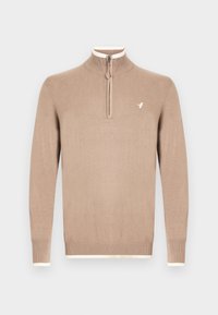 Jersey beige de punto con cuello alto y cierre de media cremallera. Presenta ribetes de color crema en el cuello y los puños, con un pequeño logo en el pecho.