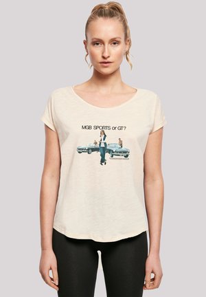 Cream-colored short-sleeve t-shirt featuring a printed graphic of two vintage cars and the text "MGB SPORTS or GT?" across the front.