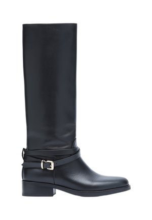 Botte haute en cuir noir avec talon bas et sangle décorative avec boucle argentée autour de la cheville, vue latérale sur fond blanc.
