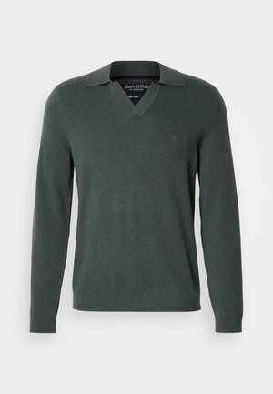 Dark green wool sweater with a v-neck and a folded collar. Features long sleeves and a subtle logo on the left chest. Smooth texture.