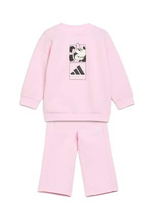 Ensemble sweat-shirt et pantalon pour enfants rose clair avec personnage de dessin animé noir et blanc et logo Adidas sur le devant du sweat-shirt.