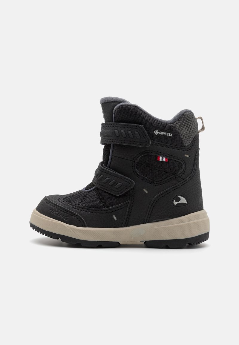 Black waterproof boot with gray accents. Features two adjustable straps, textured upper, and a durable sole. GORE-TEX branding visible.