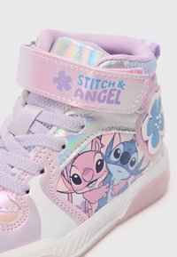 Sapatilhas altas roxas com uma fita holográfica brilhante, apresentando gráficos de Stitch e Angel, detalhes florais e detalhes texturizados nos cordões.