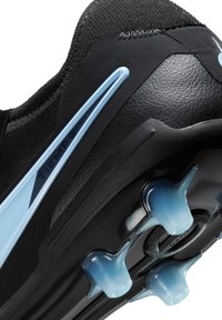 Black soccer cleat featuring a textured synthetic upper, light blue accents, and conical studs on the outsole for enhanced grip.