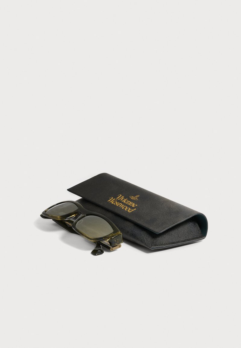 Folded translucent brown sunglasses with square lenses beside a black leather Vivienne Westwood case with gold lettering.