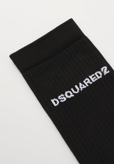 Melnas ribotas zeķes ar baltu izšūtu "DSQUARED2" logo augšējā pusē. Mīksts materiāls ar teksturētu apdari.