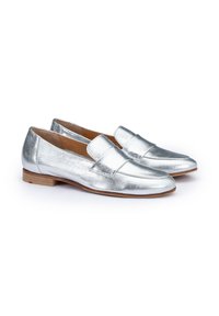 Metallic silver loafers with a smooth texture, flat heel, and a rounded toe. Feature a stitched detail and a small accent on the heel.