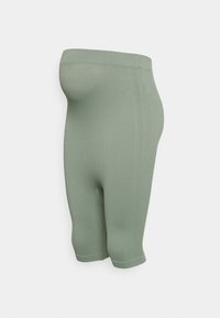 Leggings elásticos de comprimento médio em verde claro. Feitas de tecido canelado com design sem costuras e uma cintura alta para maior conforto.