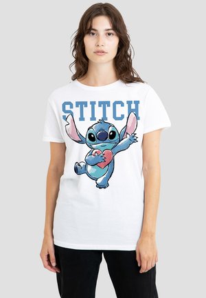 White cotton T-shirt featuring a colorful cartoon illustration of Stitch holding a heart, with the text "STITCH" above in blue.