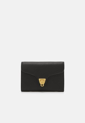 Black leather wallet with a textured finish, featuring a gold-tone clasp closure and subtle stitching along the edges. Compact rectangular shape.