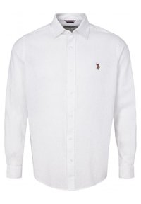 Valkoinen pellavainen pitkähiha paita, jossa on nappikiinnitteinen kaulus, pieni kirjailtu logo rinnassa ja kaareva helma.