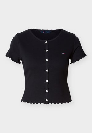 Black short-sleeve ribbed cardigan with white buttons, scalloped edges, and a small Tommy Jeans logo on the left chest.