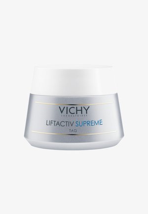 Round silver jar with a white, smooth lid; label displays "Vichy Liftactiv Supreme TAG" in blue and black text, accented with gold lines.