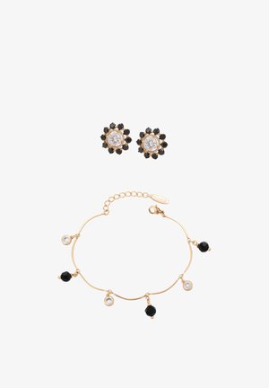 Brățară aurie cu talismane rotunde negre și transparente alternate, asortată cu cercei aurii cu șuruburi, având centre transparente înconjurate de pietre negre.