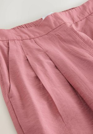 Pink, pleated women's trousers with an elastic waistband, made of lightweight fabric. Features subtle texture and side pockets.