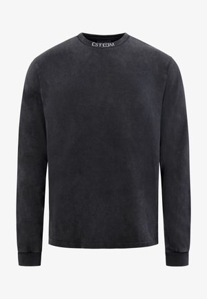 Black long-sleeve t-shirt in a soft, slightly textured fabric. Features a round neckline and subtle branding on the collar.