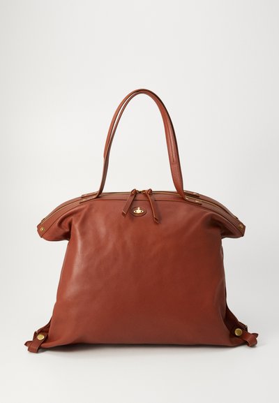 Brown leather tote bag with a zip closure, two handles, and side hardware accents. Soft texture with a rounded, spacious shape.