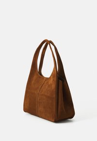 Bruine suède tote bag met een zachte textuur, ronde dubbele handvatten en karakteristieke naaddetails voor een gestructureerde maar ontspannen vorm.