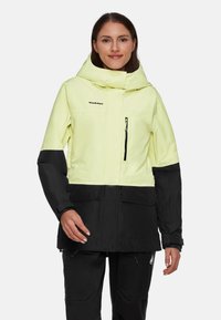 Zweifarbige Jacke in leuchtendem Gelb und Schwarz, mit Kapuze, Reißverschlusstasche auf der Brust und verstellbaren Bündchen. Hergestellt aus wasserfestem Material.