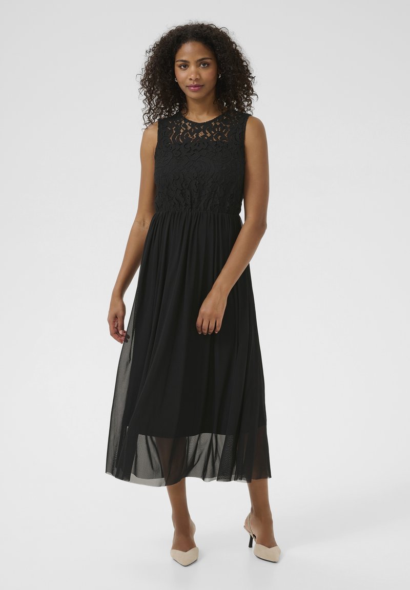 Black lace dress with sleeveless design, fitted bodice, and flowy skirt. Features sheer overlay and a textured lace neckline.
