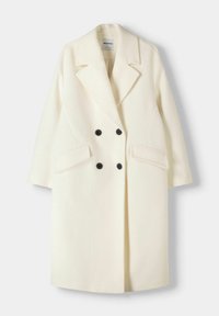 Dubbelgeknoopte jas in een off-white wollen mix, met zwarte knopen, revers met inkeping en zijzakken. Langemouwen, ontwerp tot halflengte.