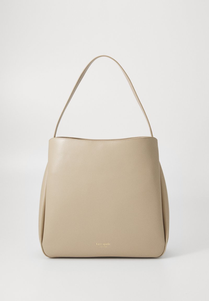 Beige leather handbag with a smooth texture, structured shape, and a single strap. Features minimalistic design and subtle branding at the bottom.