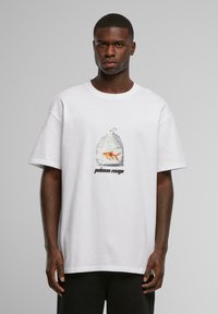 Hvid bomulds t-shirt med et grafisk motiv af en guldfisk i en plastikpose, med "poisson rouge" trykt i sort under billedet.
