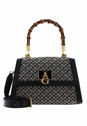 Sac à main noir et blanc à motifs avec une poignée en bambou, des accents dorés, des bordures en cuir texturé et une bandoulière amovible.