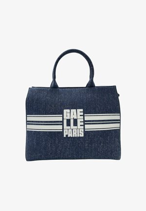 Borsa tote in denim blu scuro con due manici, caratterizzata da strisce orizzontali bianche e testo "GAELLE PARIS" in lettere bianche in grassetto.