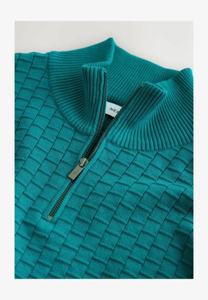 Pullover lavorato a maglia color teal con colletto con zip, caratterizzato da un motivo a quadrati testurizzati e colletto a costine. Il dettaglio della zip è di tono argentato.