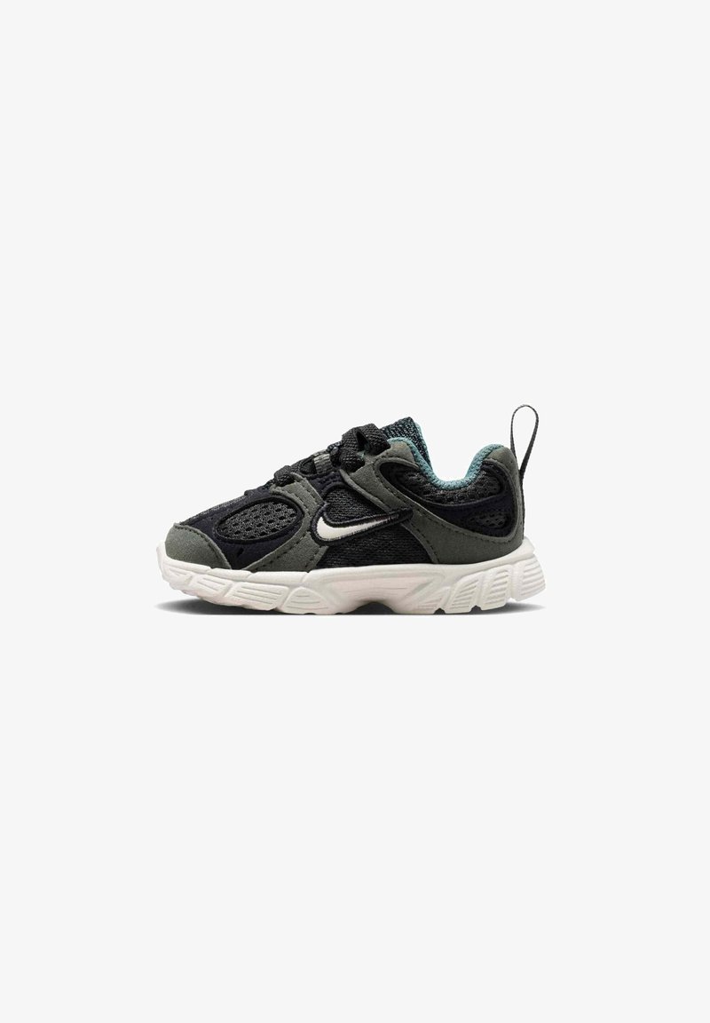 Black and gray toddler sneaker with white sole, mesh and suede materials, black laces, Nike logo on the side, and a heel pull tab.