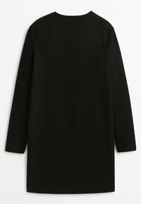 Black wool dress with long sleeves, straight cut, and a rounded neckline. Soft texture, minimalistic design, and no visible hardware.