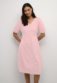 Pink and white striped dress with a V-neck, short puff sleeves, and knee-length design. Features a smooth texture and straight silhouette.