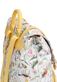 Floral print backpack with yellow leather accents and straps. Features a rounded shape, smooth texture, and detailed illustrations of flowers and animals.