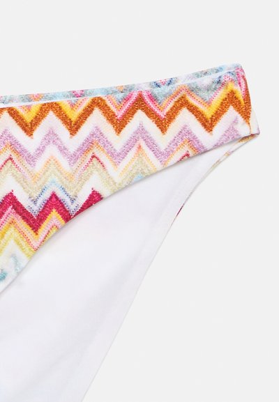 Bas de maillot de bain blanc avec un motif en zigzag multicolore sur la ceinture aux nuances d'orange, de rose, de jaune et de bleu.