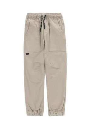 Jasnobeżowe casualowe spodnie z elastycznym pasem, czarnym sznurkiem, dwiema naszywanymi kieszeniami z przodu oraz elastycznymi ściągaczami na kostkach.