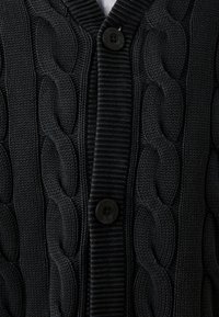 Black knitted cardigan featuring a cable knit pattern, textured with a ribbed collar and button closure for a snug fit.