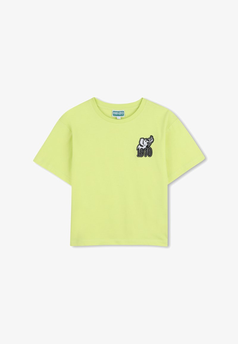 T-shirt court à manches courtes de couleur vert citron avec col rond et petite écusson d'un éléphant au-dessus de l'année 1970 sur la poitrine.