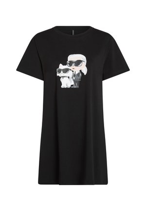 Svart T-shirt klänning med en cartoon-grafik av en person och en vit katt, båda med solglasögon. Tillverkad av mjuk bomullstyg.