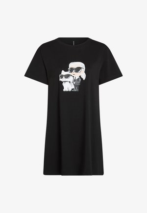 Fekete pólóruha, amelyen egy napszemüveget viselő személy és egy fehér macska rajzolódik, mindketten napszemüveget viselnek. Puha pamutból készült.