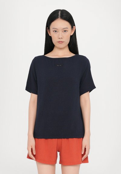 Navy blue short-sleeve shirt with a wide neckline, featuring a small embroidered detail at the center. Soft texture and relaxed fit.