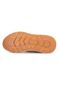Rubber shoe sole with a textured orange exterior, featuring a geometric pattern of triangular and diamond shapes for grip.