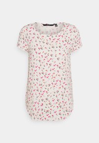 Blusa de manga corta en tejido ligero, color crema, con un patrón floral en rosa y negro. Escote redondo y corte holgado.