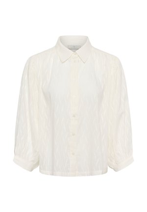 Chemise blanche à boutons avec col, manches bouffantes et motif en zigzag texturé. Réalisée en tissu léger.