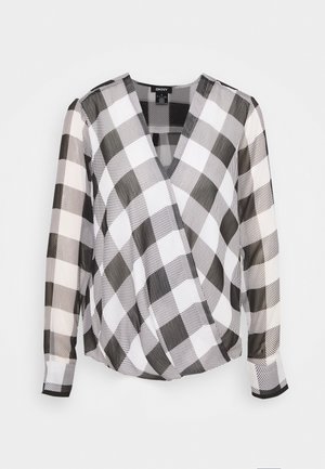 Blouse à manches longues noir et blanc à motifs à carreaux, avec un col en V et un devant croisé, fabriquée par DKNY.