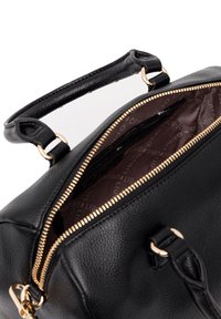 Black leather handbag with a textured surface, gold zipper closure, and a brown interior featuring a logo pattern. Top handle for carrying.