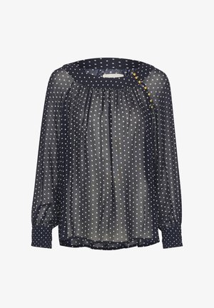 Blusa transparente azul marino con lunares blancos, cuello redondo con detalles de botones y mangas largas con puños ajustados.
