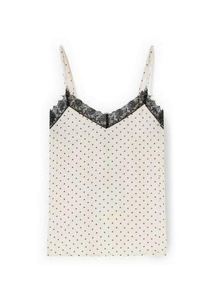 Camisola crema con lunares negros y adorno de encaje negro a lo largo del escote en V y las tiras.